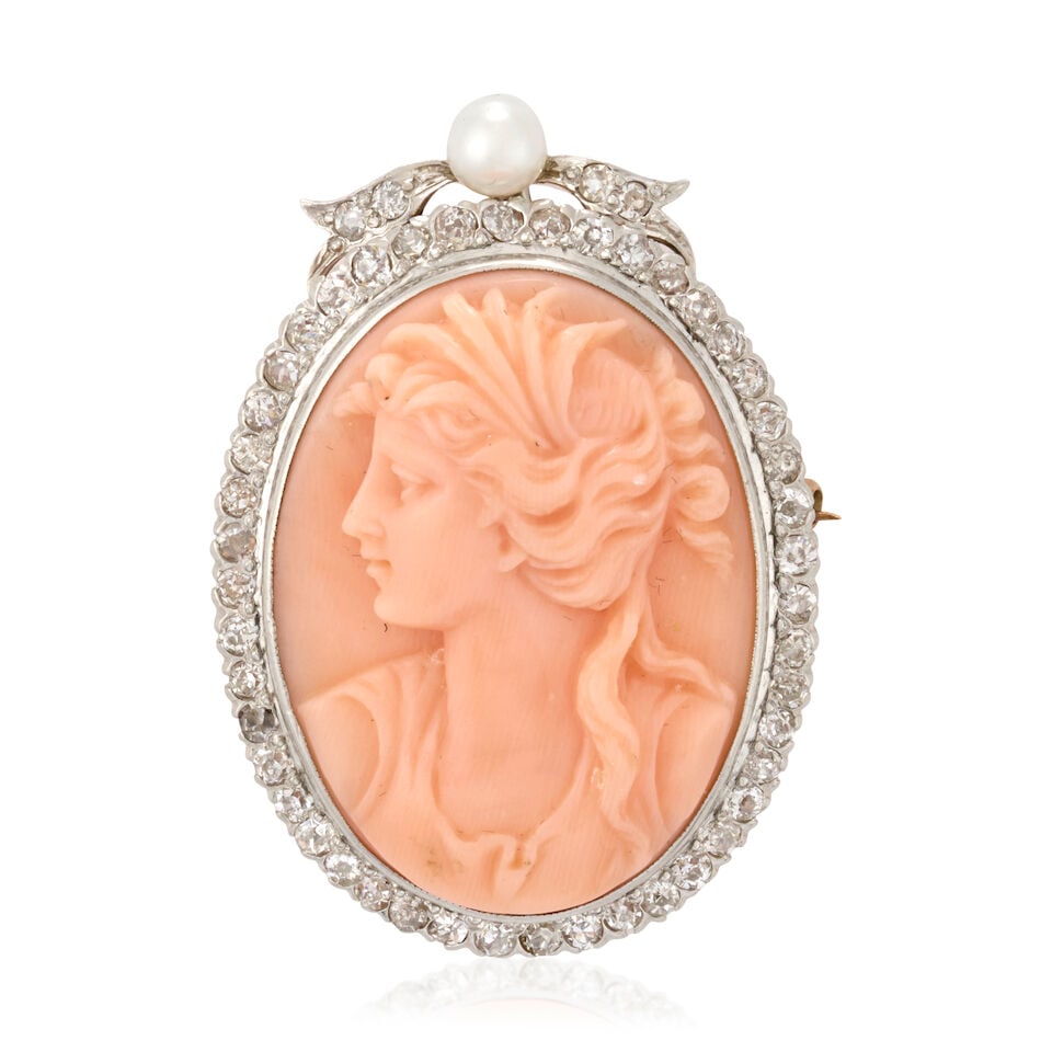 AN ANTIQUE CORAL CAMEO, PEARL, AND DIAMOND PENDANT/BROOCH: AN ANTIQUE CORAL CAMEO, PEARL, AND DIAMOND PENDANT/BROOCH Centering a carved coral cameo depicting a maiden in profile, framed by single-cut diamonds, and topped by a pearl and diamond bow, approximat