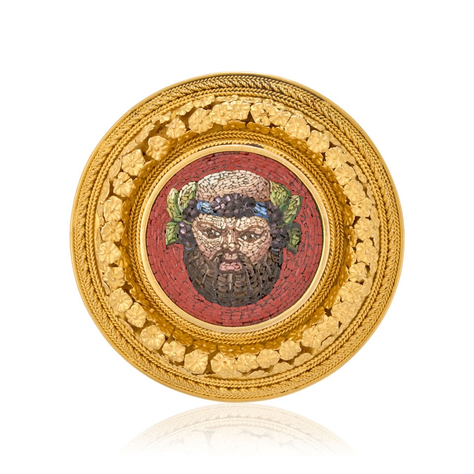 AN ANTIQUE GOLD AND MICROMOSAIC BROOCH: AN ANTIQUE GOLD AND MICROMOSAIC BROOCH The central micromosaic depicting Bacchus, bezel-set within an applied floral and ropetwist frame, weight 12.9 dwt, length 1 5/8 in. For further information on t