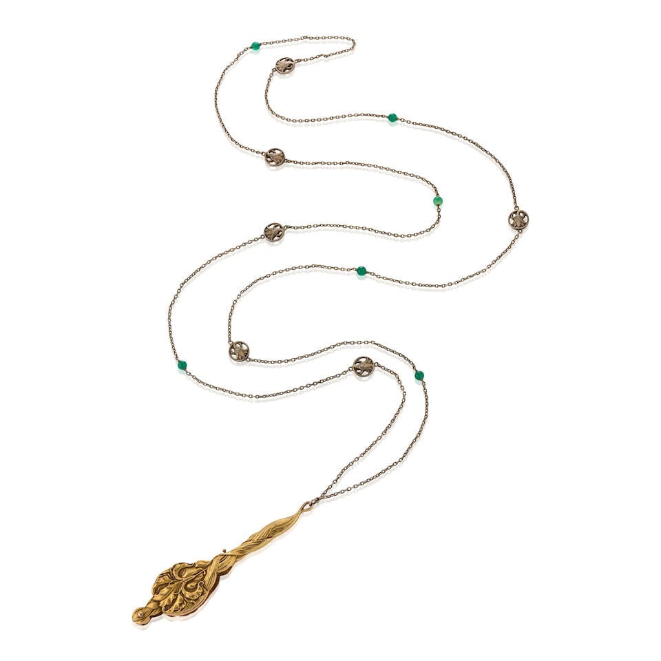 AN ART NOUVEAU 14K GOLD LORGNETTE: AN ART NOUVEAU 14K GOLD LORGNETTE The repoussé lorgnette designed as an iris to one side, with iris leaves and engraved initials en verso, suspended from a long silver chain with lotus flower