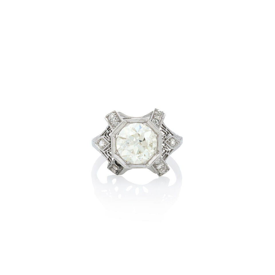 AN ART DECO PLATINUM AND DIAMOND RING: AN ART DECO PLATINUM AND DIAMOND RING Centering an old European-cut diamond weighing approximately 1.99 carats, in a filligree mount set with old mine and old single-cut diamonds, millegrain accents, 