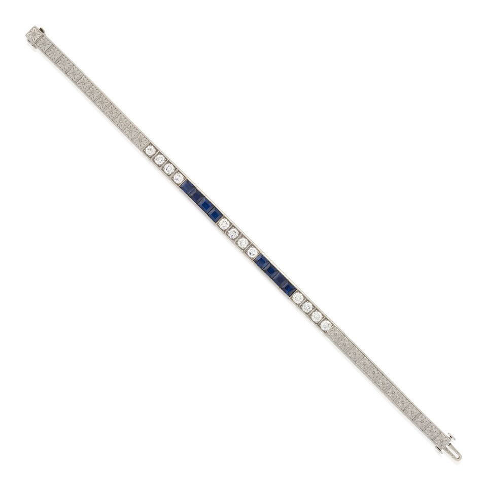 J.E. CALDWELL & CO.: AN ART DECO PLATINUM, SAPPHIRE, AND DIAMOND LINE BRACELET: J.E. CALDWELL & CO.: AN ART DECO PLATINUM, SAPPHIRE, AND DIAMOND LINE BRACELET Set with fancy-cut sapphires and old European-cut diamonds, approximate total diamond weight 1.30 carats, with engraved