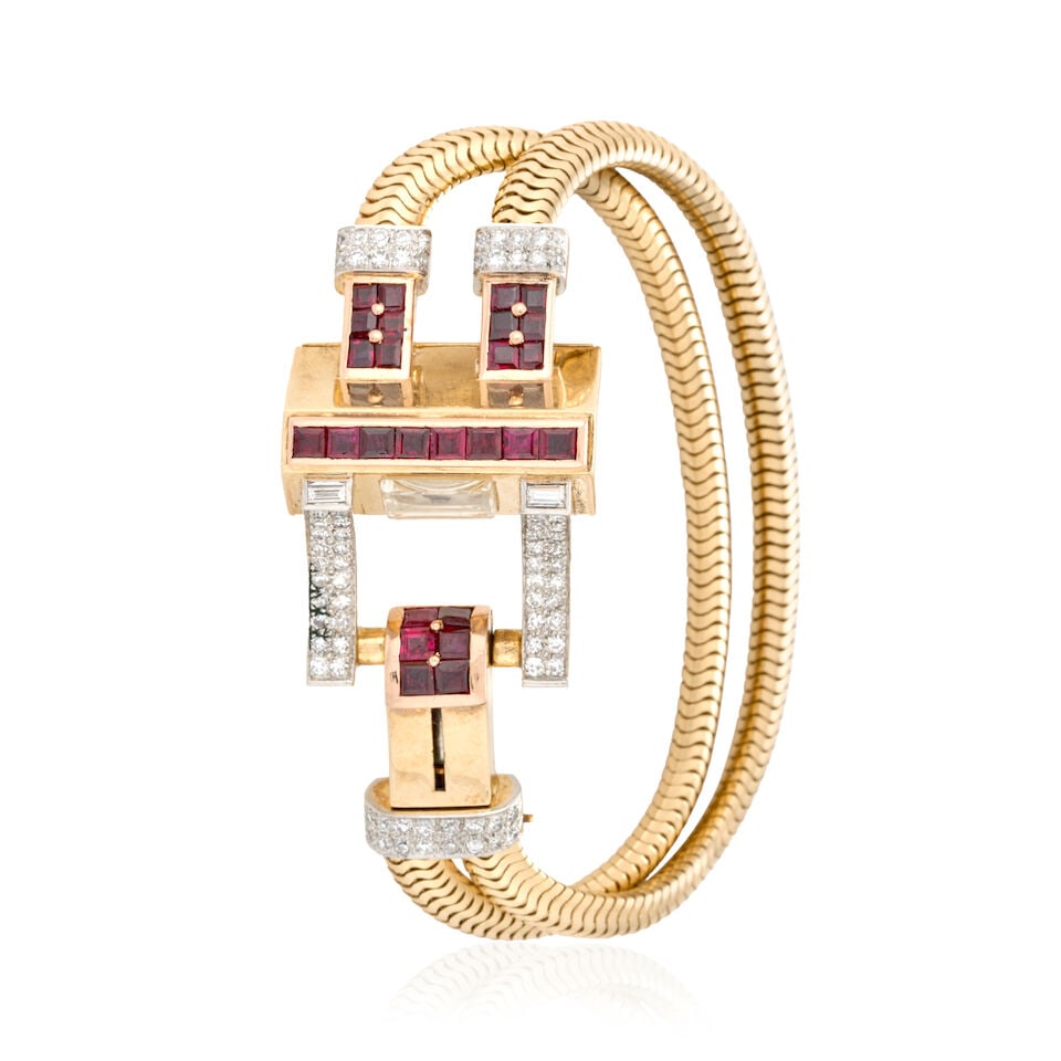 HAYDEN W. WHEELER: A RETRO 14K GOLD, RUBY, AND DIAMOND BRACELET WATCH: HAYDEN W. WHEELER: A RETRO 14K GOLD, RUBY, AND DIAMOND BRACELET WATCH Designed as a buckle with channel-set step-cut rubies, and single-cut diamonds set in platinum, with square dial enclosing a manua
