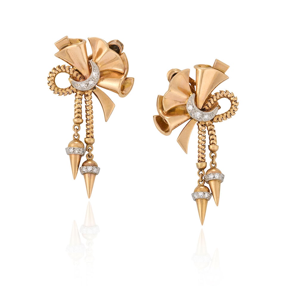 A PAIR OF RETRO GOLD AND DIAMOND EARCLIPS: A PAIR OF RETRO GOLD AND DIAMOND EARCLIPS The ribbon forms suspending pointed drops, with single-cut diamond accents set in platinum, weight 10.2 dwt, length 1 3/4 in. For further information on this