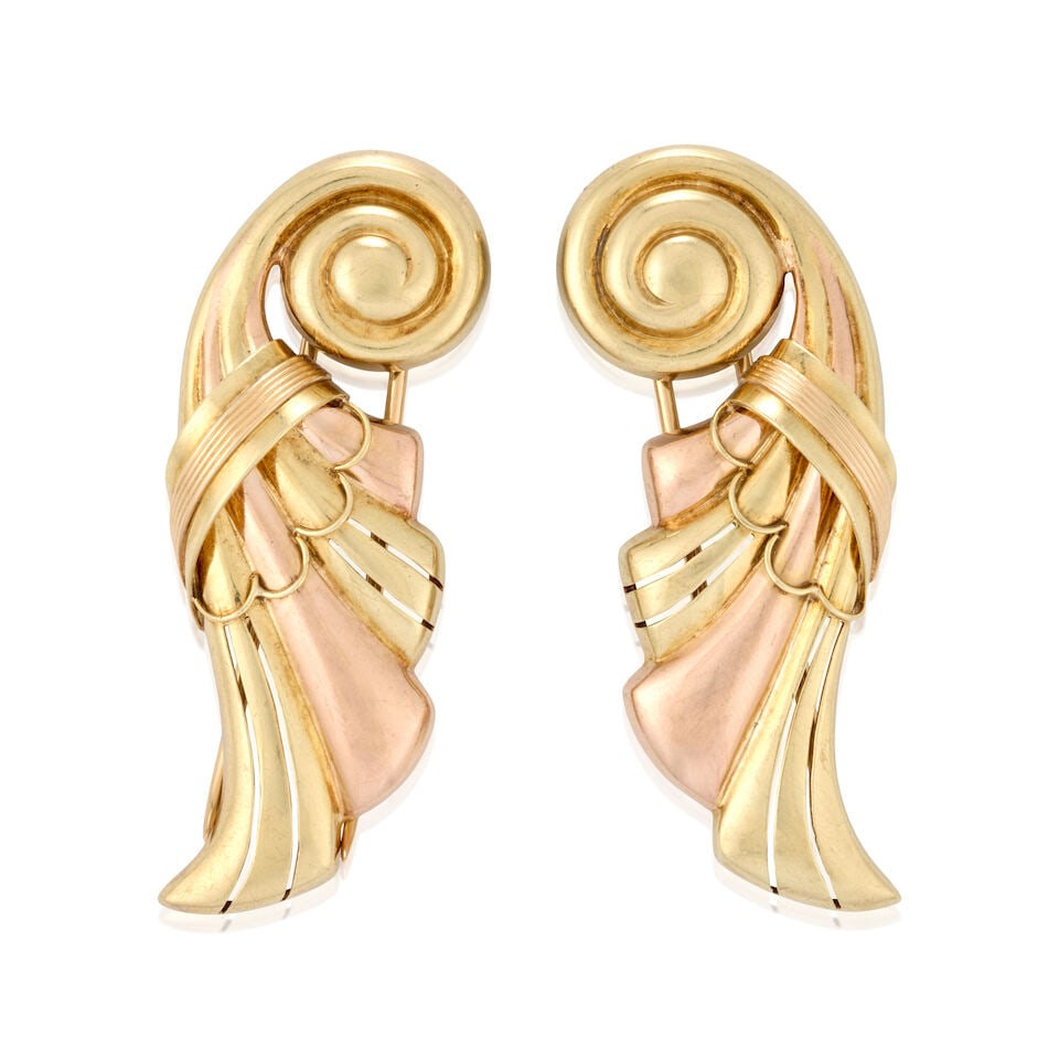 SLOAN & CO.: A PAIR OF RETRO 14K BI-COLOR GOLD CLIP BROOCHES: SLOAN & CO.: A PAIR OF RETRO 14K BI-COLOR GOLD CLIP BROOCHES The scrolled design unfurling into rose and yellow gold plumes, weight 14.1 dwt, maker's mark for Sloan & Co., length 2 3/16 in. For