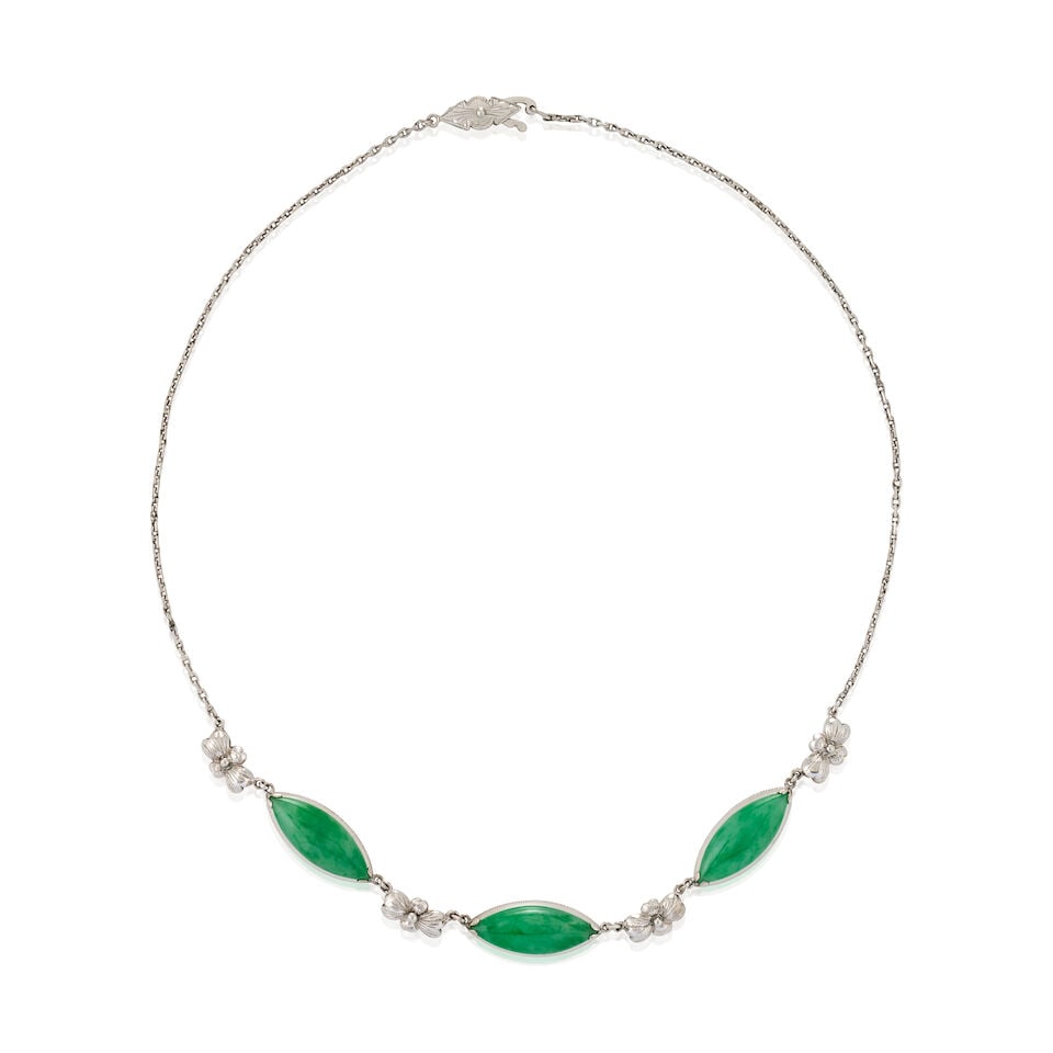 A 14K WHITE GOLD AND JADEITE NECKLACE: A 14K WHITE GOLD AND JADEITE NECKLACE Centering three navette-shape cabochon jades, each measuring approximately 20.40 x 7.75 x 3.75 mm, joined by engraved flower links, weight 8.5 dwt, length 15 1/4 