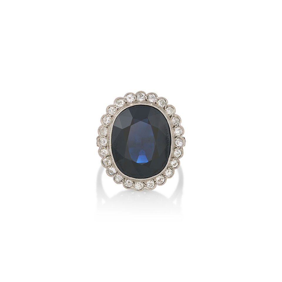 A PLATINUM, SAPPHIRE, AND DIAMOND RING, FRANCE: A PLATINUM, SAPPHIRE, AND DIAMOND RING, FRANCE Centering a large fancy-cut sapphire measuring approximately 16.60 x 13.60 x 7.25 mm, framed by old single and old mine-cut diamonds, millegrain accents,