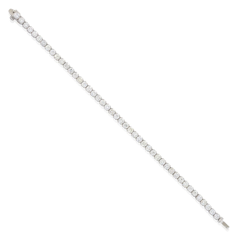 A 14K WHITE GOLD AND DIAMOND BRACELET: A 14K WHITE GOLD AND DIAMOND BRACELET Set with full-cut diamonds, total weight 7.57 carats, weight 7.7 dwt, length 7 in. For further information on this lot please visit Bonhams.com For further