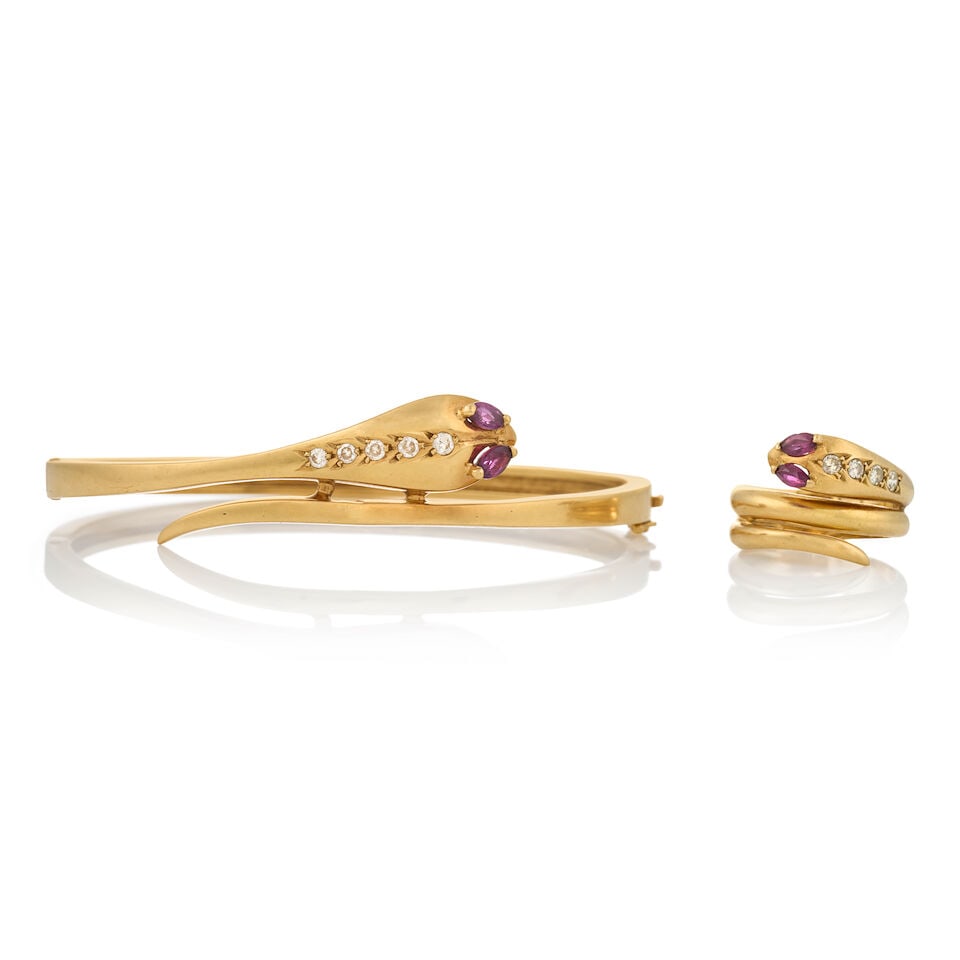 AN 18K GOLD, RUBY, AND DIAMOND SNAKE BRACELET AND RING: AN 18K GOLD, RUBY, AND DIAMOND SNAKE BRACELET AND RING Each designed as a coiled snake with fancy-cut ruby eyes, the hinged bangle set with full-cut diamonds, and the ring with single-cut diamonds,