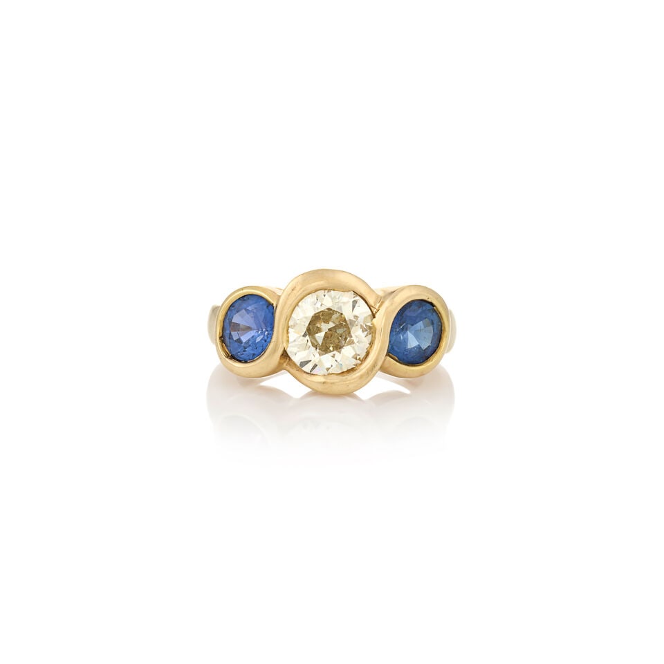 A 14K GOLD, SAPPHIRE, AND DIAMOND RING: A 14K GOLD, SAPPHIRE, AND DIAMOND RING Centering a full-cut diamond weighing approximately 1.30 carats, flanked by circular-cut sapphires, each measuring approximately 5.60 x 5.60 x 3.45 mm, weight
