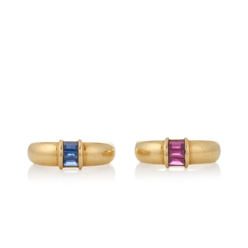 TIFFANY & CO.: TWO 18K GOLD GEM-SET BANDS: TIFFANY & CO.: TWO 18K GOLD GEM-SET BANDS Centering channel-set baguette-cut sapphires and rubies, weight 5.1 dwt, signed Tiffany & Co., size 6. For further information on this lot please visit Bonham