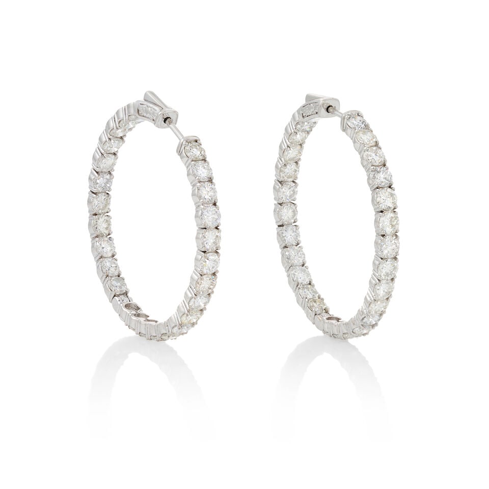 A PAIR OF 14K WHITE GOLD AND DIAMOND HOOP EARRINGS: A PAIR OF 14K WHITE GOLD AND DIAMOND HOOP EARRINGS Set with full-cut diamonds, total weight 9.06 carats, weight 8.2 dwt, length 1 1/2 in. For further information on this lot please visit
