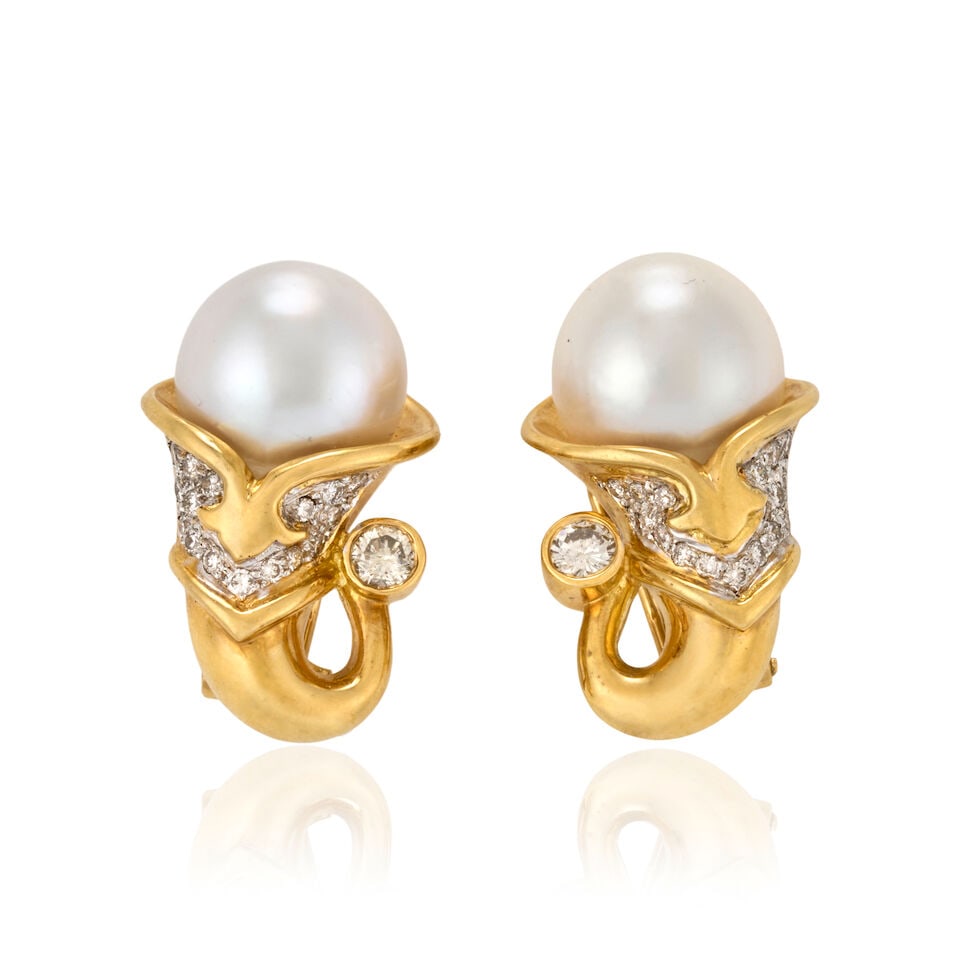 A PAIR OF 18K GOLD, SOUTH SEA PEARL, AND DIAMOND EARCLIPS: A PAIR OF 18K GOLD, SOUTH SEA PEARL, AND DIAMOND EARCLIPS Designed as cornucopias, each set with a South Sea pearl measuring approximately 13.10 mm, and full-cut diamonds, weight 15.2 dwt, length 1