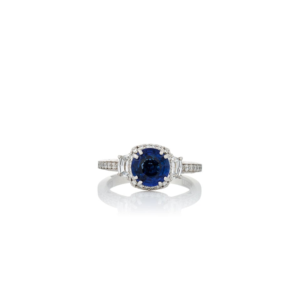 TACORI: AN 18K WHITE GOLD, SAPPHIRE, AND DIAMOND RING: TACORI: AN 18K WHITE GOLD, SAPPHIRE, AND DIAMOND RING Centering a circular-cut sapphire measuring approximately 7.10 xc 7.10 x 3.75 mm, and set with epaulette and full-cut diamonds, pierced white
