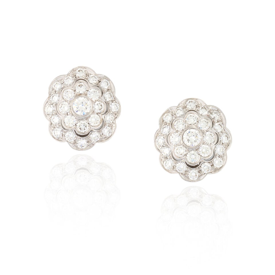 A PAIR OF 18K WHITE GOLD AND DIAMOND EARRINGS: A PAIR OF 18K WHITE GOLD AND DIAMOND EARRINGS Designed as flowers set with full-cut diamonds, approximate total weight 2.90 carats, weight 6.4 dwt, length 11/16 in. For further information on this