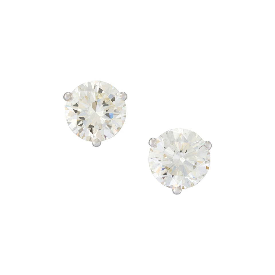 A PAIR OF DIAMOND EARSTUDS: A PAIR OF DIAMOND EARSTUDS Set with full-cut diamonds weighing 1.18 and 1.11 carats, in 14k white gold, length 1/4 in. For further information on this lot please visit Bonhams.com For further