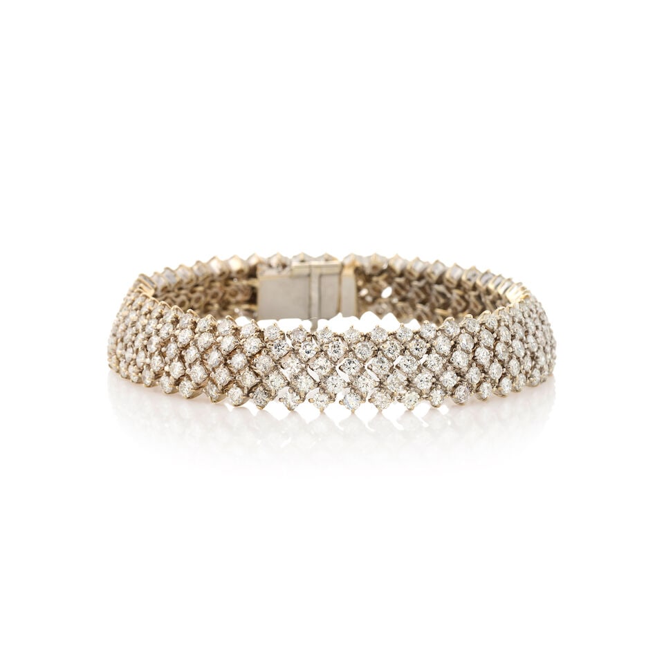 A GOLD AND DIAMOND BRACELET: A GOLD AND DIAMOND BRACELET Set with full-cut diamonds, approximate total weight 9.85 carats, weight 25.7 dwt, length 6 3/4 in. For further information on this lot please visit Bonhams.com For