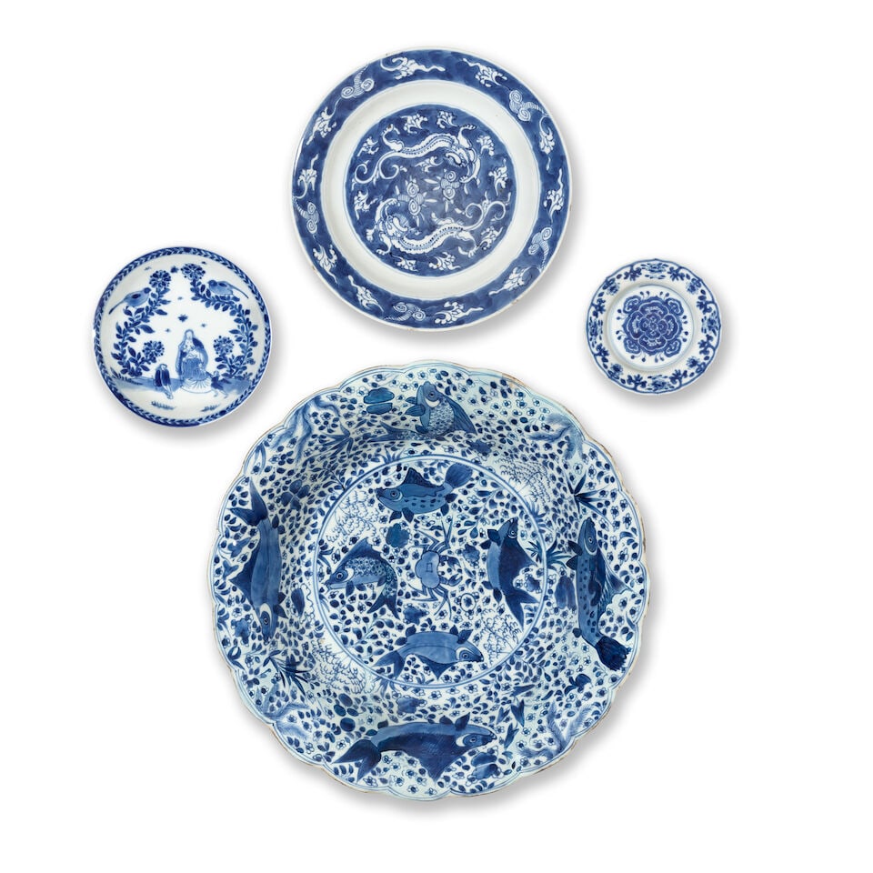 FOUR BLUE AND WHITE DISHES Kangxi (4): FOUR BLUE AND WHITE DISHES Kangxi Comprising: a large dish rising from a short tapered foot to flaring sides ending at a foliate rim, painted to the interior with a central medallion enclosing four fi