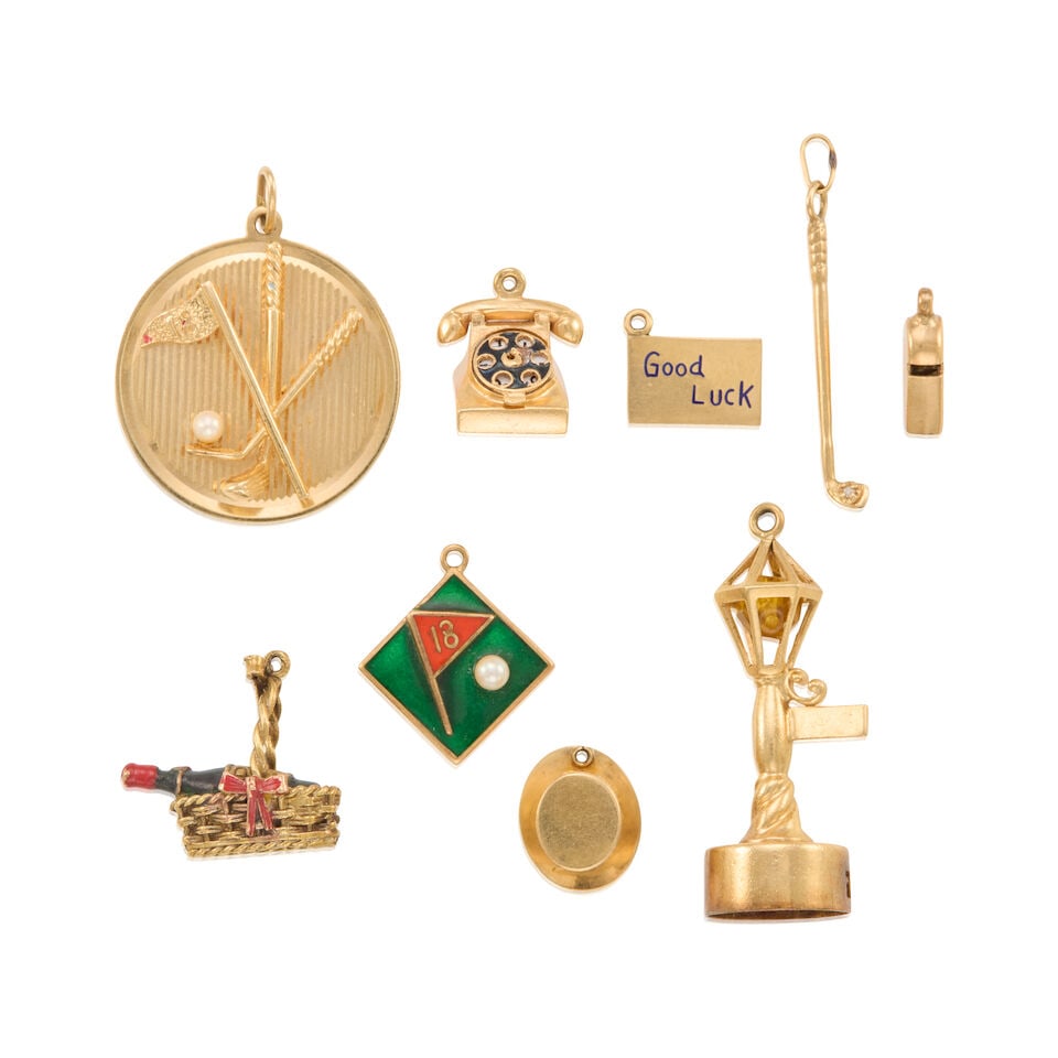 A GROUP OF GOLD CHARMS: A GROUP OF GOLD CHARMS • A 14K yellow gold top hat charm, measures 9/16 in. x 1/2 in. • A 14K yellow gold whistle charm, measures 5/8 in. x 5/16 in. • A 14K yellow gold golf club