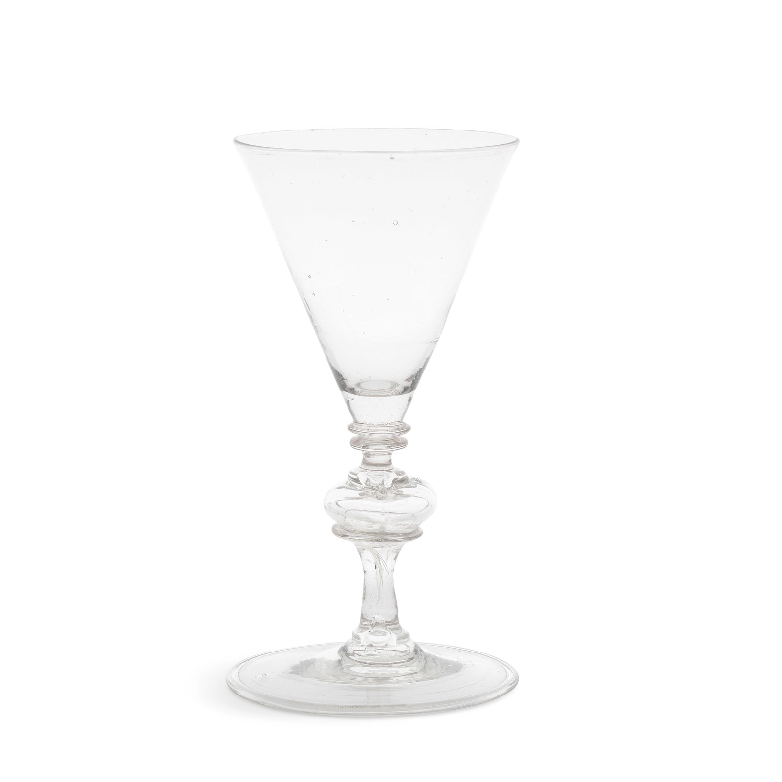 A good façon de Venise wine glass, late 17th century: A good façon de Venise wine glass, late 17th century Low Countries or perhaps English, the delicate conical bowl with a solid base, set on two collars above a hollow quatrefoil knop resting on a 