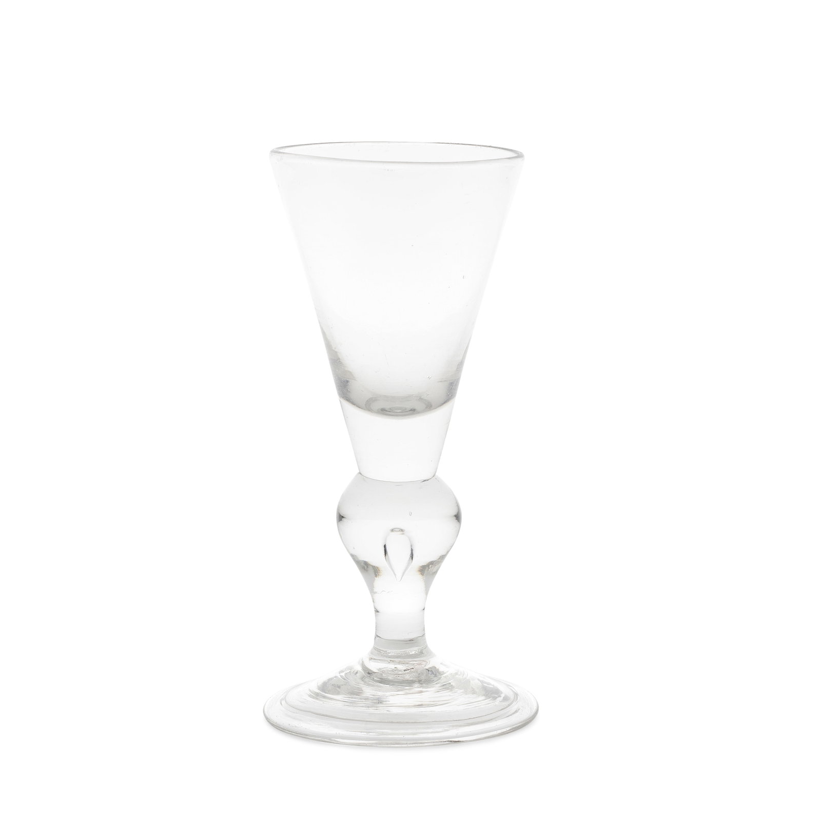 A good heavy baluster wine glass, circa 1710: A good heavy baluster wine glass, circa 1710 The conical bowl with a solid base, on a teared inverted baluster stem, over a conical folded foot, 17cm high Footnotes: Provenance John and Pamela White C