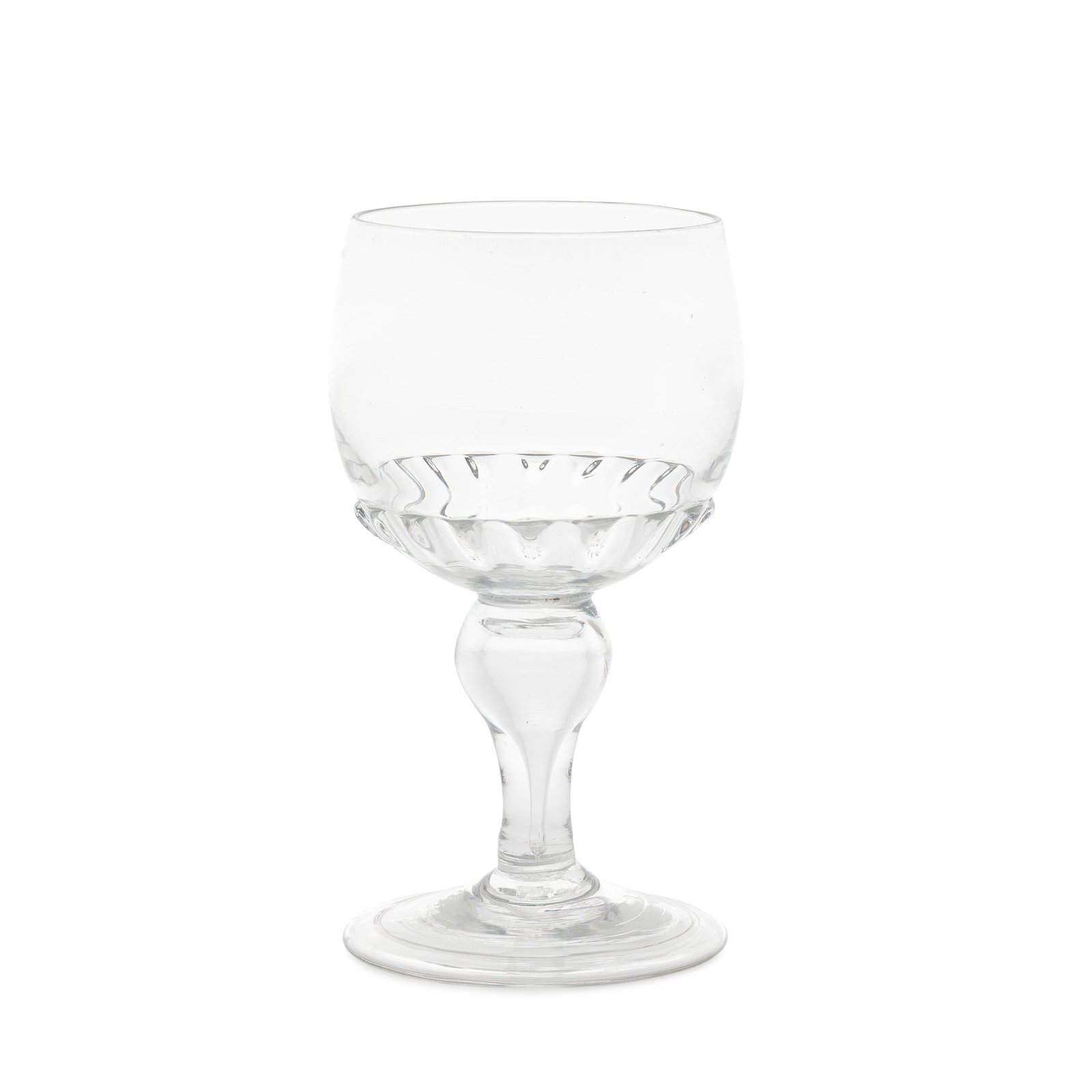 A rare and early baluster roemer, circa 1700: A rare and early baluster roemer, circa 1700 The generous cup-shaped bowl moulded with gadroons to the lower part, set on a teared inverted baluster stem, over a conical folded foot, 14.4cm high Footn