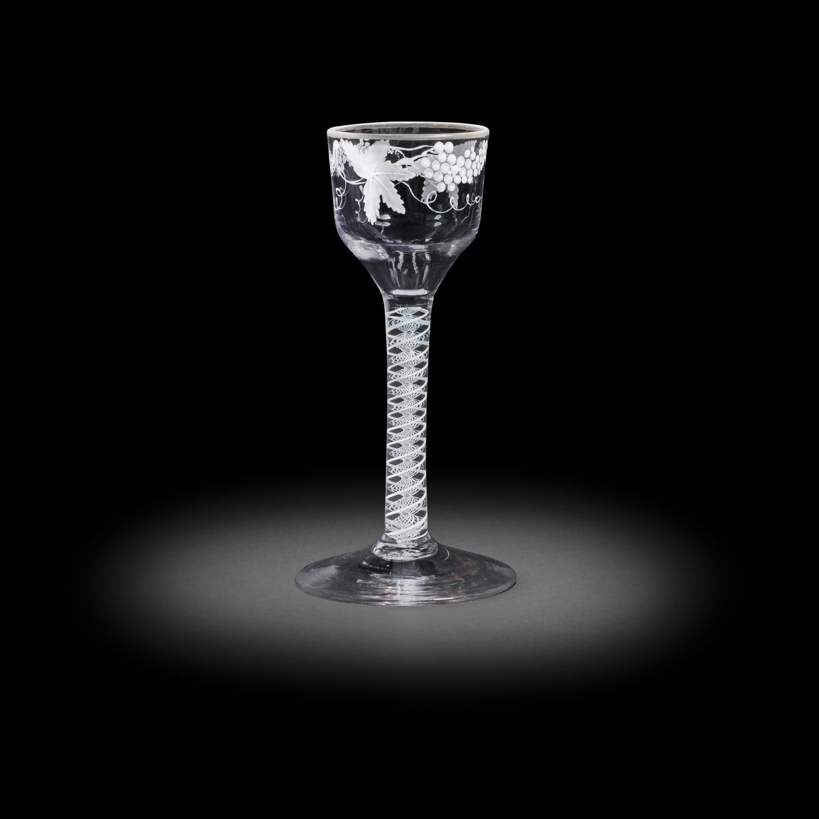 A Beilby enamelled opaque twist wine glass, circa 1765: A Beilby enamelled opaque twist wine glass, circa 1765 The ogee bowl painted with fruiting vine in opaque white, faint traces of gilding to the rim, set on a double-series stem containing a pair of op