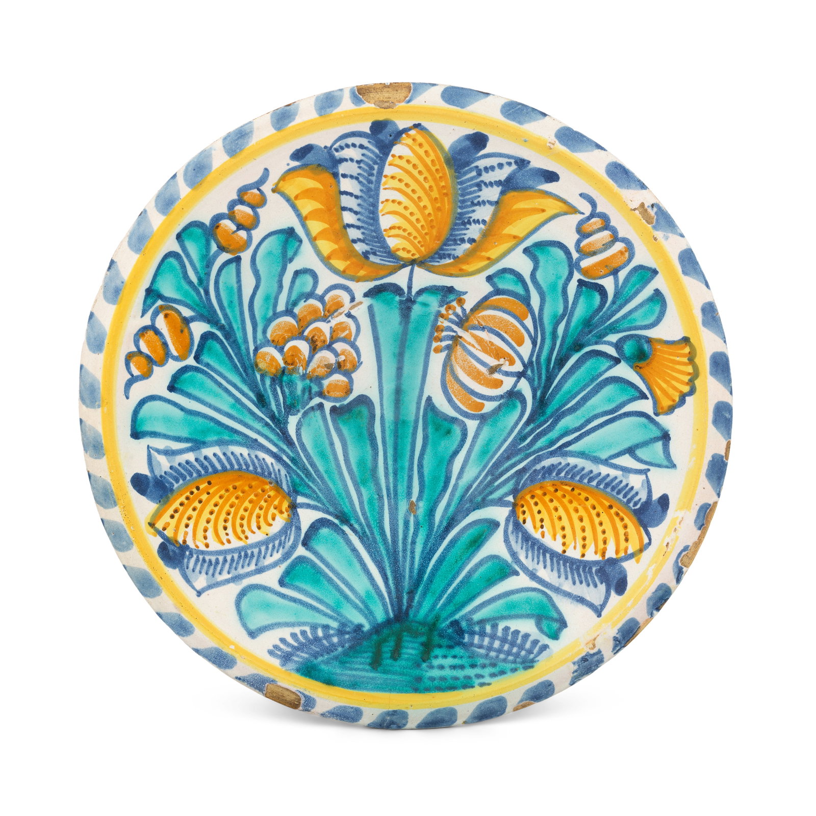 A London delftware tulip charger, circa 1685-1695: A London delftware tulip charger, circa 1685-1695 Probably Southwark, boldly painted in blue, turquoise, and ochre with three tulips, a lily, spiral buds and another flower, broad leaves issuing from 