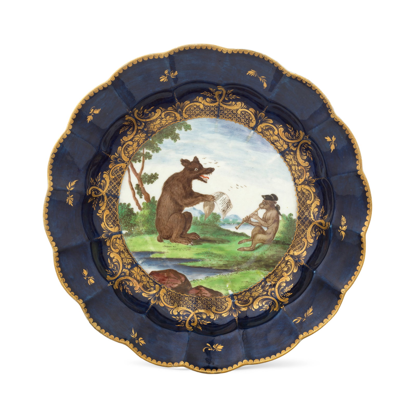 A rare Worcester dish, circa 1768-70: A rare Worcester dish, circa 1768-70 Of lobed circular shape, the large central panel painted by Jefferyes Hamett O'Neale with a seated bear singing from sheet music, accompanied by a monkey wearing
