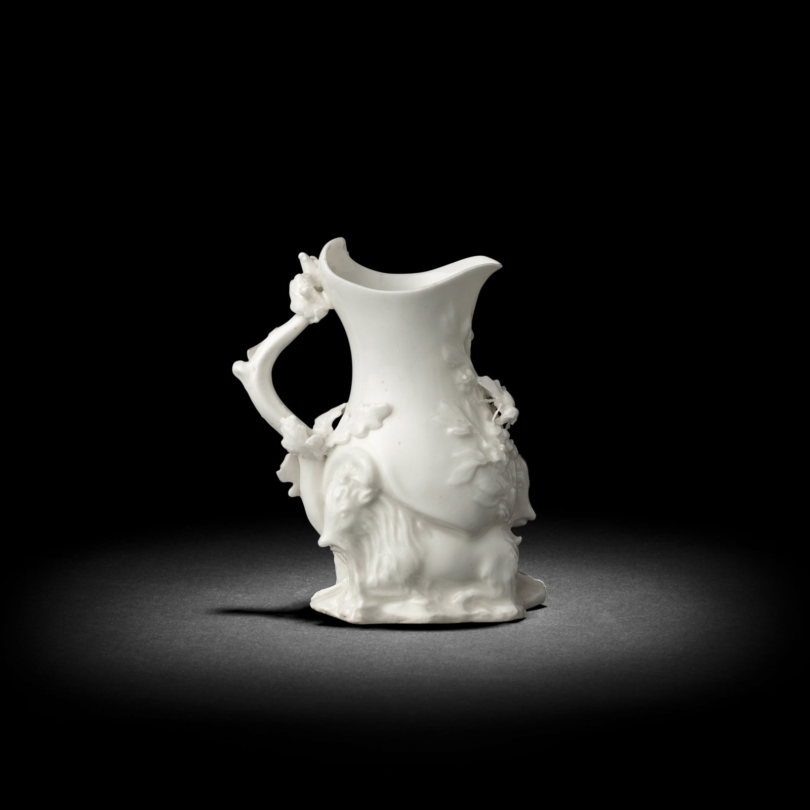 A good Chelsea white 'Goat and Bee' jug, circa 1745-49: A good Chelsea white 'Goat and Bee' jug, circa 1745-49 Probably modelled by Nicholas Sprimont, finely modelled with a branch handle applied with oak leaves, the lower section comprising two resting go