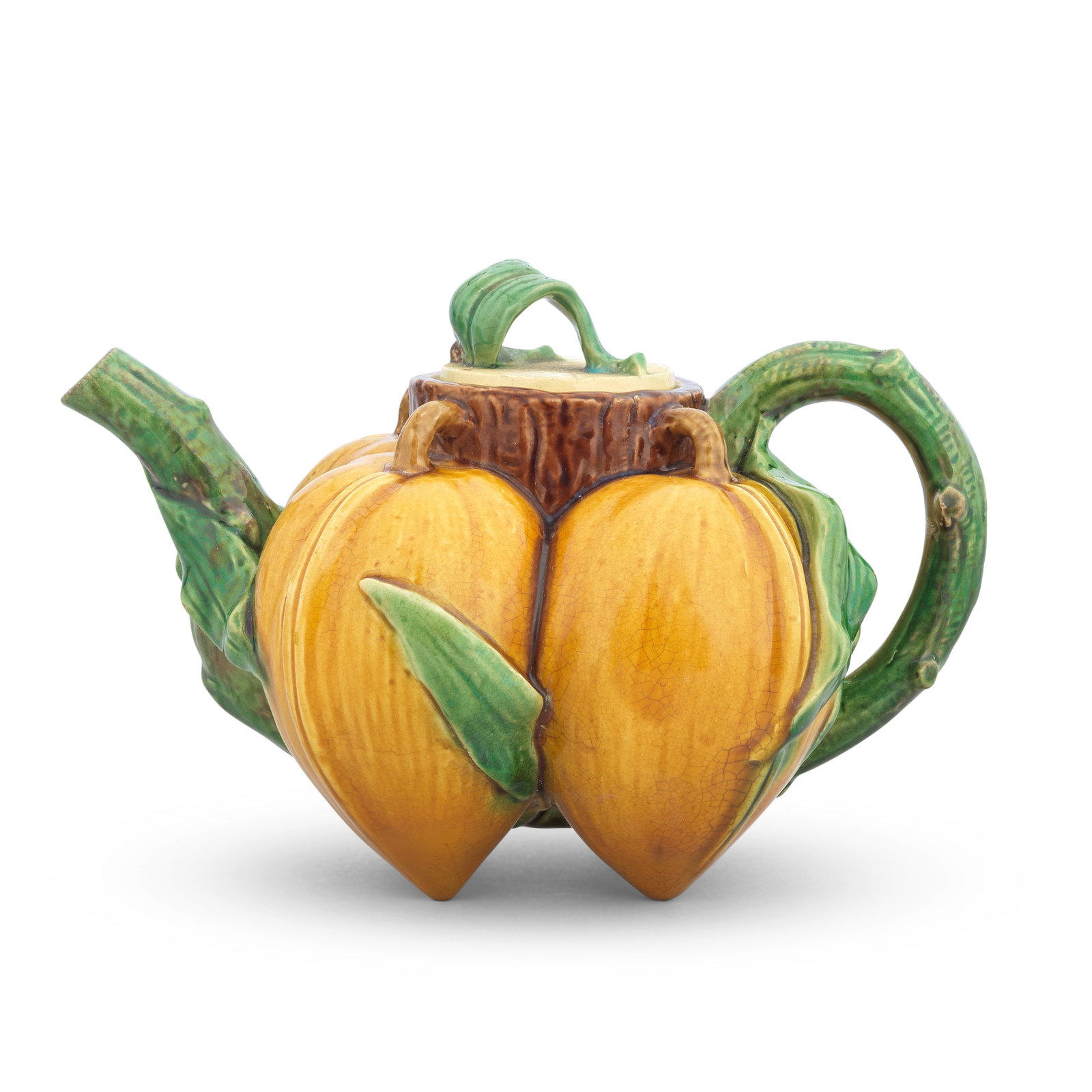 A rare Minton majolica 'lychees' teapot and cover, dated 1868: A rare Minton majolica 'lychees' teapot and cover, dated 1868 Modelled as four conjoined lychee fruit issuing from a central trunk forming the neck, the green stalk handle and spout formed from a sing