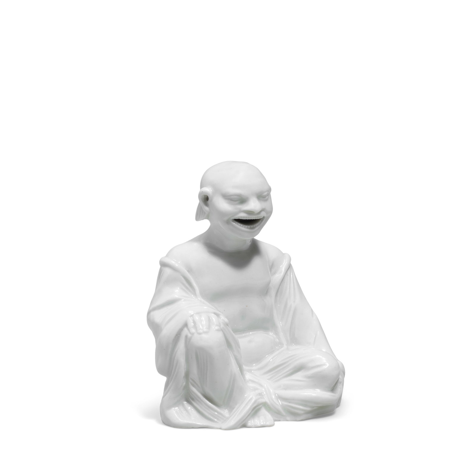A Meissen white figure of a seated pagoda from the Japanese Palace, circa 1715-20: A Meissen white figure of a seated pagoda from the Japanese Palace, circa 1715-20 Crisply moulded, with his right hand resting on his upraised right knee, the mouth and ears pierced, 9.5cm high, incis