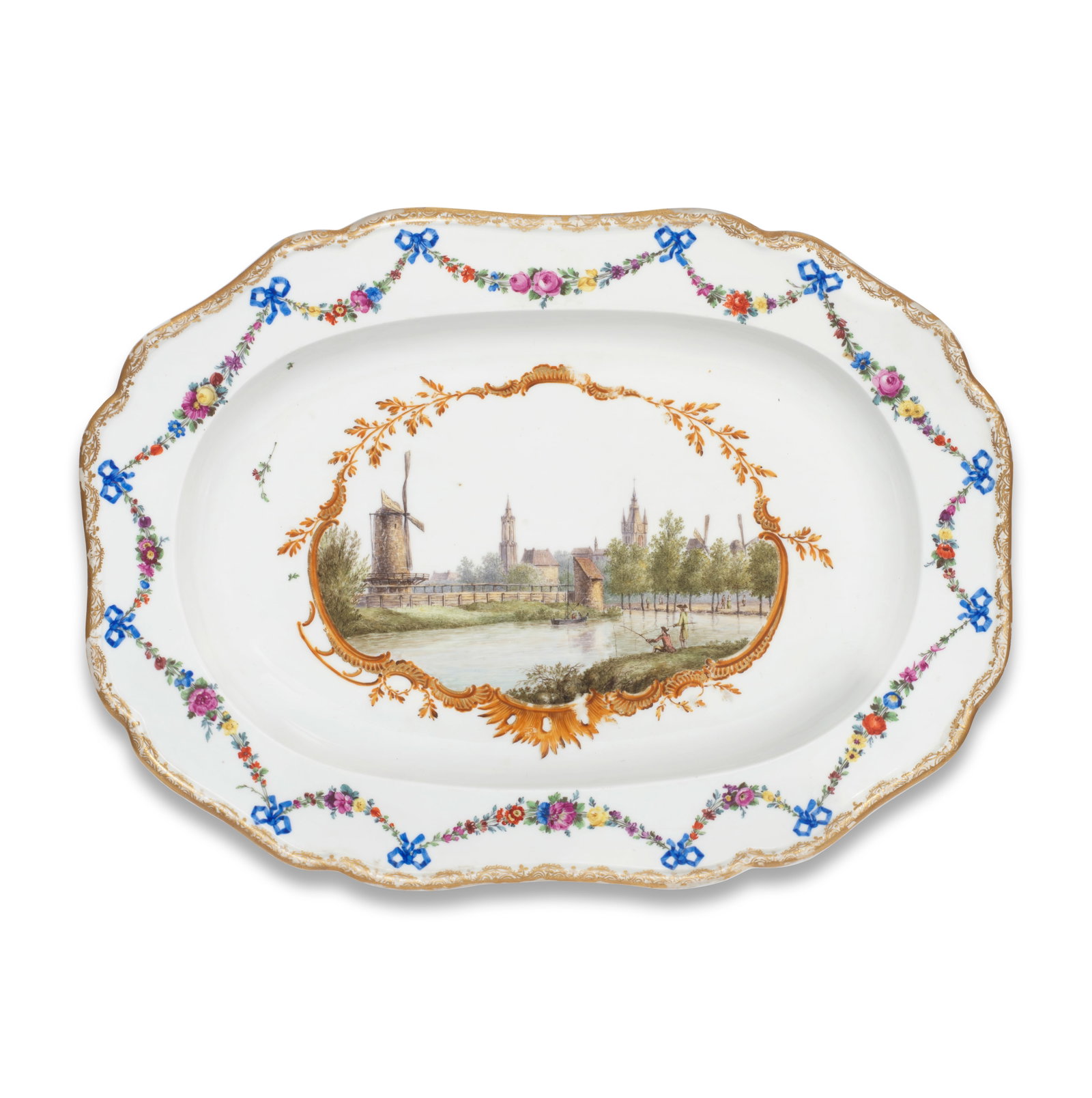 A Meissen large oval topographical stand with Dutch view, circa 1774: A Meissen large oval topographical stand with Dutch view, circa 1774 Painted in the centre with a view of fishermen by a river with churches and windmills in the background, within a gilt and brown sc