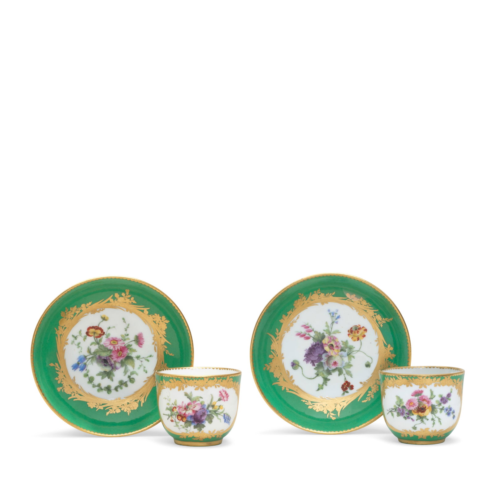 A pair of Sèvres green-ground cups and saucers (gobelet Bouillard et soucoupe), dated 1773: A pair of Sèvres green-ground cups and saucers (gobelet Bouillard et soucoupe), dated 1773 Of the second size, each reserved with a panel painted with a flower spray with a gilt foliate and flora