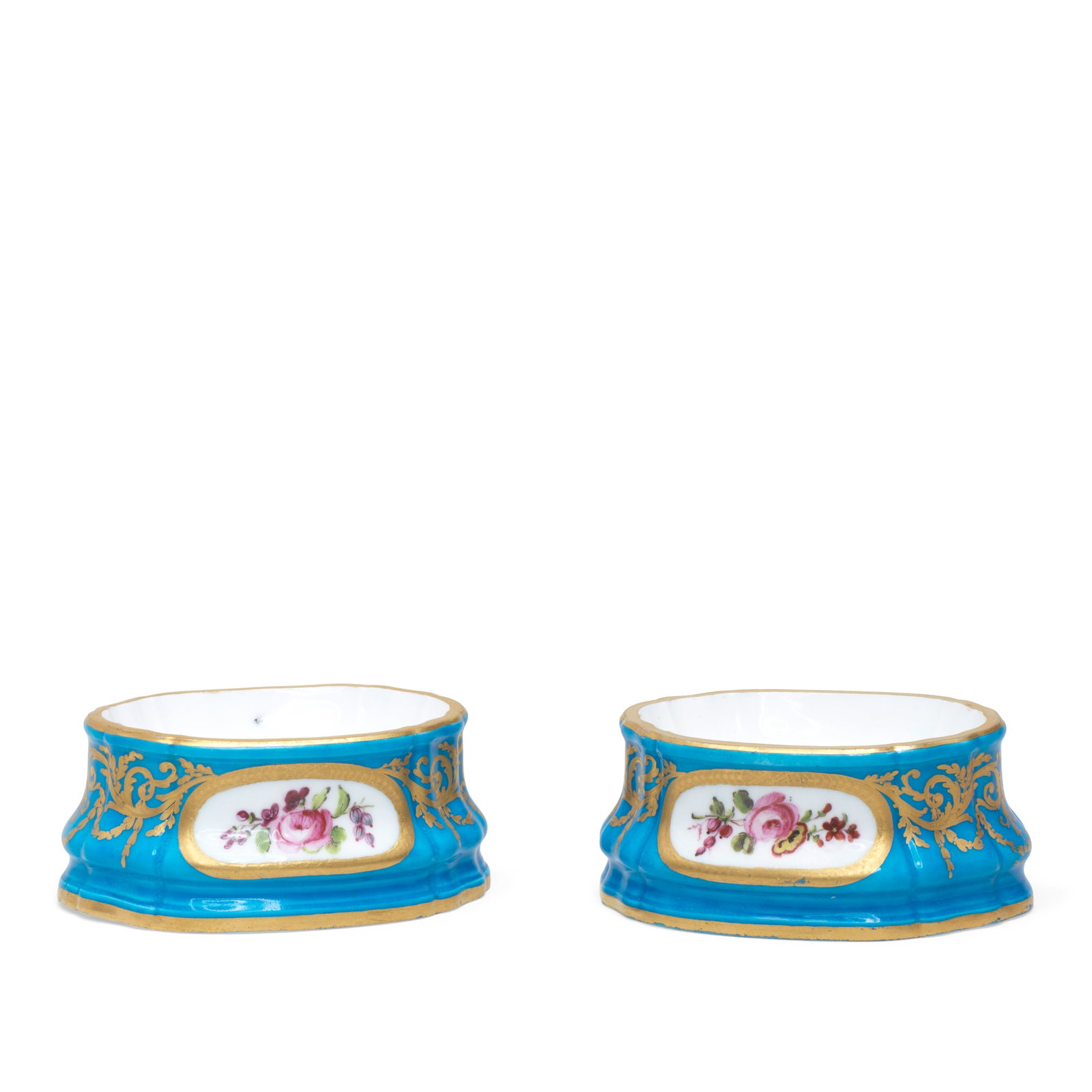 A pair of Sèvres bleu céleste-ground oval salts (salière simple), dated 1787: A pair of Sèvres bleu céleste-ground oval salts (salière simple), dated 1787 Each side reserved with an oval panel painted with flowers by François-Claude Philippine within gilt fr