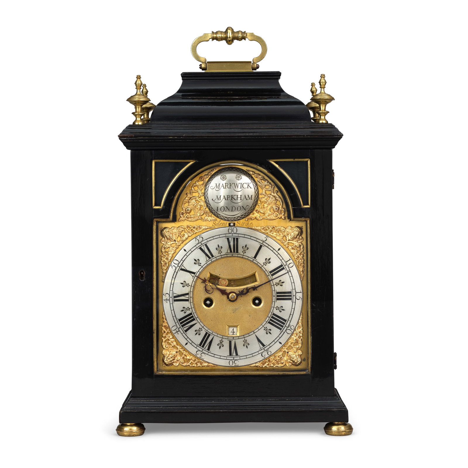 A mid 18th century ebonised quarter repeating table clock Markwick, Markham, London: A mid 18th century ebonised quarter repeating table clock Markwick, Markham, London The case surmounted by a knopped brass carrying handle over an inverted bell top with turned finials to each corner 