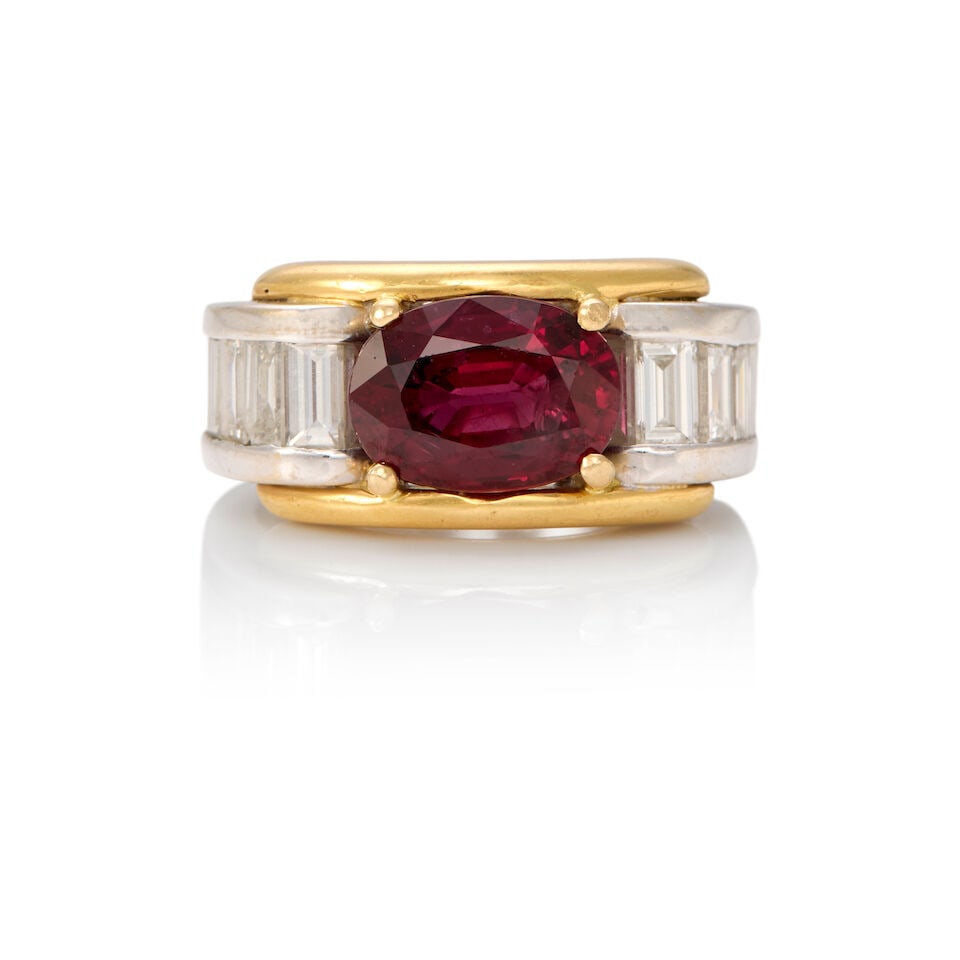 18K BICOLORED GOLD, RUBY, AND DIAMOND RING WITH GIA REPORT: 18K BICOLORED GOLD, RUBY, AND DIAMOND RING WITH GIA REPORT • One oval shaped ruby measuring 10.91mm x 7.83mm x 5.00mm • Twelve rectangular shaped diamonds weighing approximately 1.30