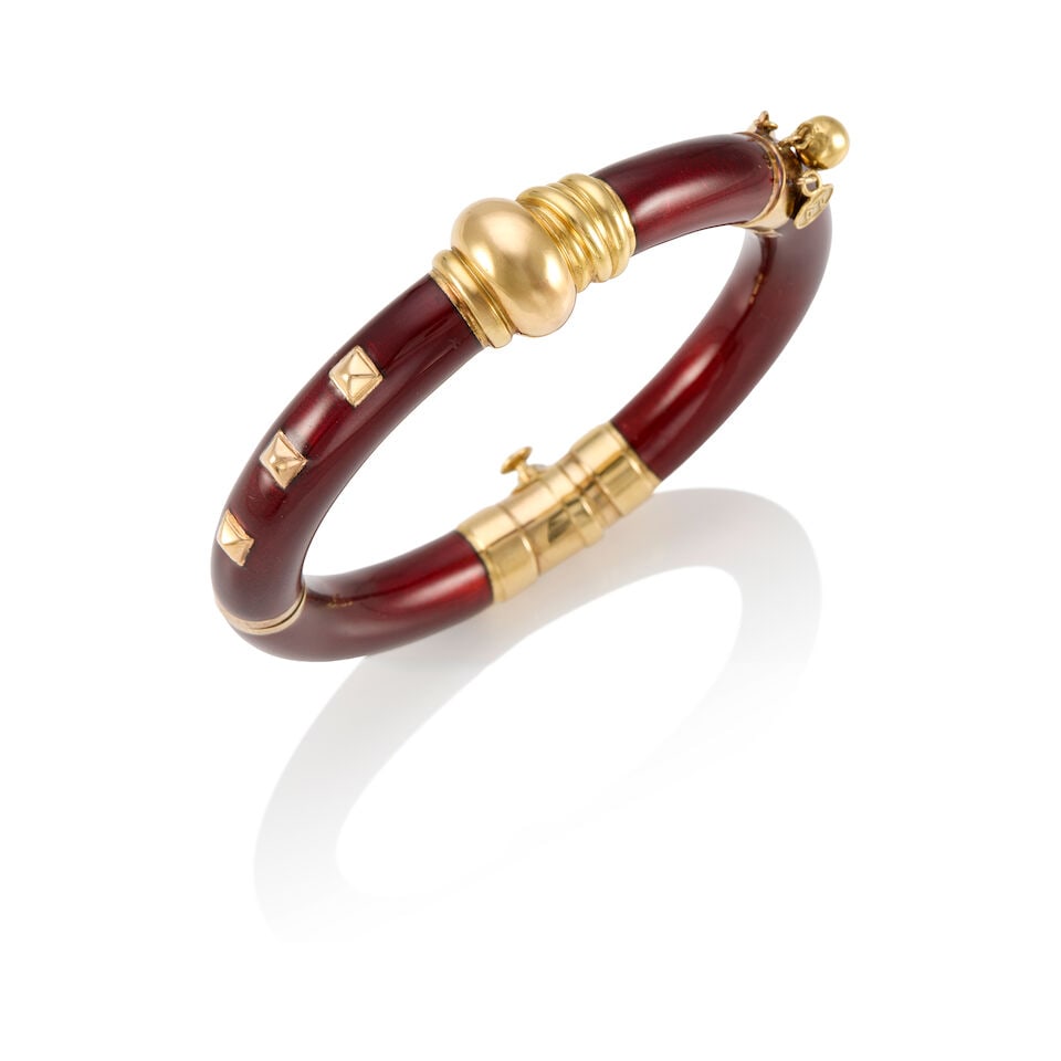 NOUVELLE BAGUE: AN 18K YELLOW GOLD, STERLING SILVER, AND ENAMEL BANGLE BRACELET: NOUVELLE BAGUE: AN 18K YELLOW GOLD, STERLING SILVER, AND ENAMEL BANGLE BRACELET • Enamel topped silver with 18K gold • Three gold charms • Stamped NOUVELLE BAGUE • Inner