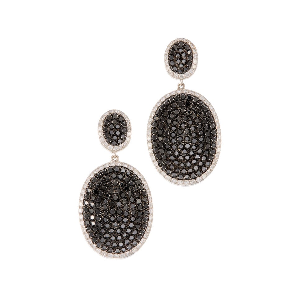A PAIR OF 18K WHITE GOLD, DIAMOND, AND BLACK DIAMOND EARRINGS: A PAIR OF 18K WHITE GOLD, DIAMOND, AND BLACK DIAMOND EARRINGS • Numerous round shaped diamonds weighing approximately 3.70 carats total • Measures 1 1/2 in. x 13/16 in. • Estimated