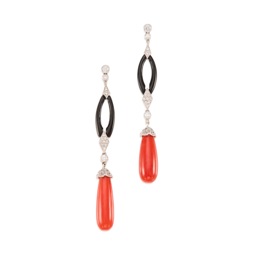 A PAIR OF 18K WHITE GOLD, CORAL, ONYX, AND DIAMOND EARRINGS: A PAIR OF 18K WHITE GOLD, CORAL, ONYX, AND DIAMOND EARRINGS • Two carved coral pieces measuring approximately 17.31mm x 5.98mm • Two carved and oval shaped onyx pieces measuring