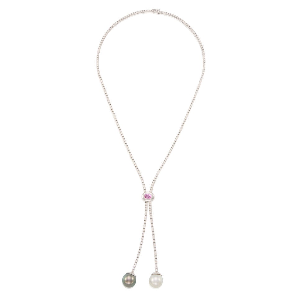 AN 18K WHITE GOLD, PINK SAPPHIRE, AND CULTURED PEARL LARIAT NECKLACE: AN 18K WHITE GOLD, PINK SAPPHIRE, AND CULTURED PEARL LARIAT NECKLACE • An oval shaped sapphire weighing approximately 0.70 carat • Two cultured pearls measuring approximately 13.03mm in