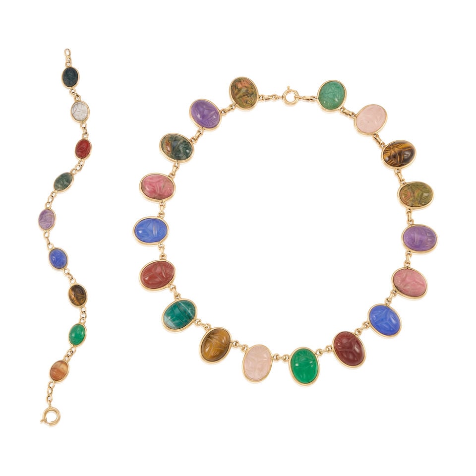 14K YELLOW GOLD AND CHALCEDONY NECKLACE AND BRACELET: 14K YELLOW GOLD AND CHALCEDONY NECKLACE AND BRACELET • A gold necklace with numerous carved chalcedony cabochons measuring approximately 15.64mm x 12.31mm x 6.71mm, length 14 in. • A gold