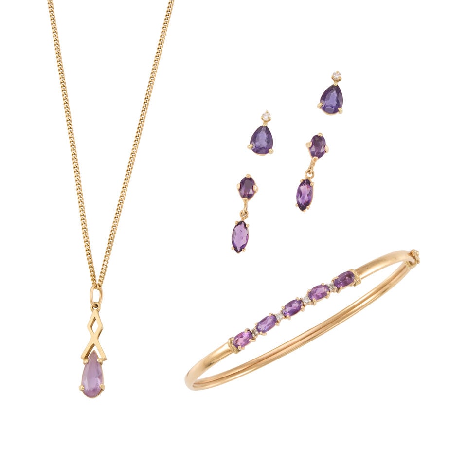 A GROUP OF YELLOW GOLD AND AMETHYST JEWLERY: A GROUP OF YELLOW GOLD AND AMETHYST JEWLERY • A 14K yellow gold bangle with five oval shaped amethysts weighing approximately 0.90 carat total, with four round shaped diamonds weighing