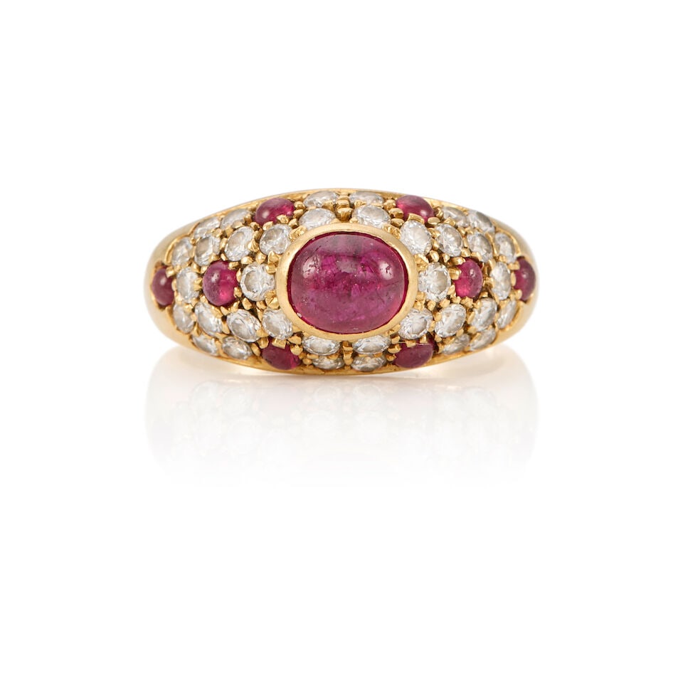 A 18K YELLOW GOLD, DIAMOND, AND RUBY RING: A 18K YELLOW GOLD, DIAMOND, AND RUBY RING • Nine cabochon rubies weighing approximately 1.50 carats total • Numerous round shaped diamonds weighing approximately 0.70 carat total •