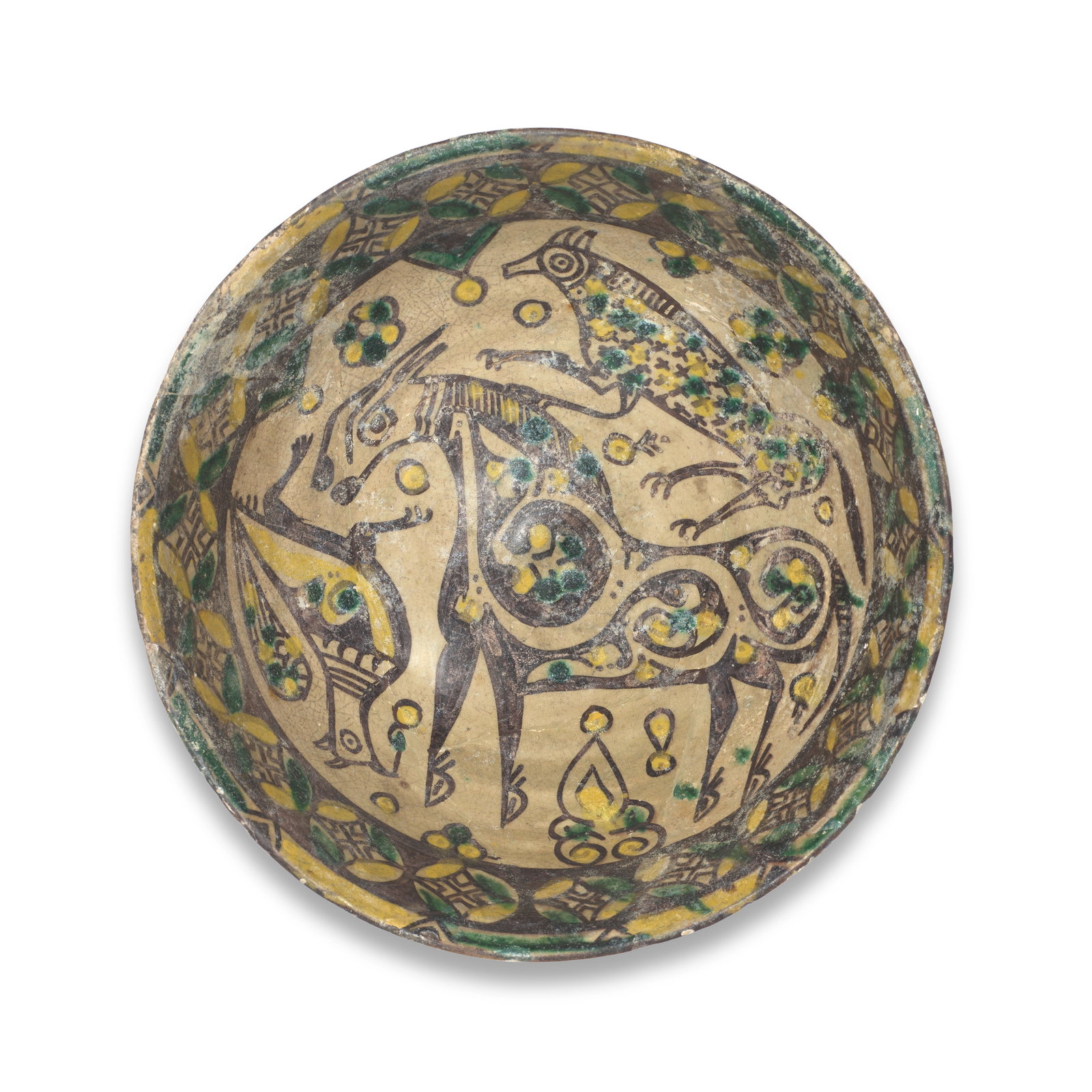 A Nishapur buffware pottery bowl Persia, 10th Century: A Nishapur buffware pottery bowl Persia, 10th Century Of deep rounded form on a short foot, decorated in yellow, green and manganese on a buff ground with a central horse motif surrounded by another q
