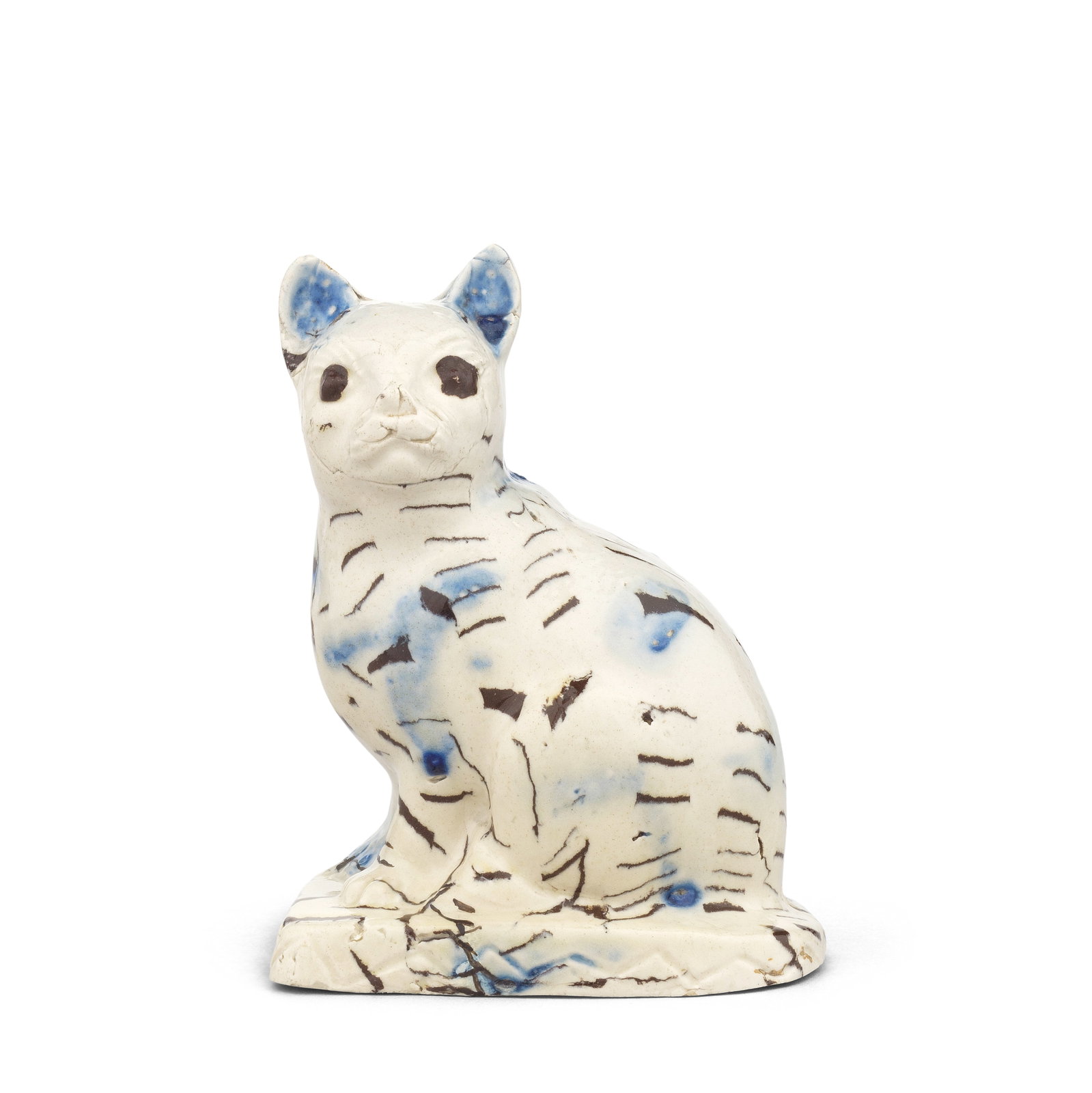 A Staffordshire saltglaze model of a cat, circa 1750: A Staffordshire saltglaze model of a cat, circa 1750 In two tones of dark brown and white 'solid agate' and splashed in blue glaze, modelled seated on its haunches with an alert expression, the rectan