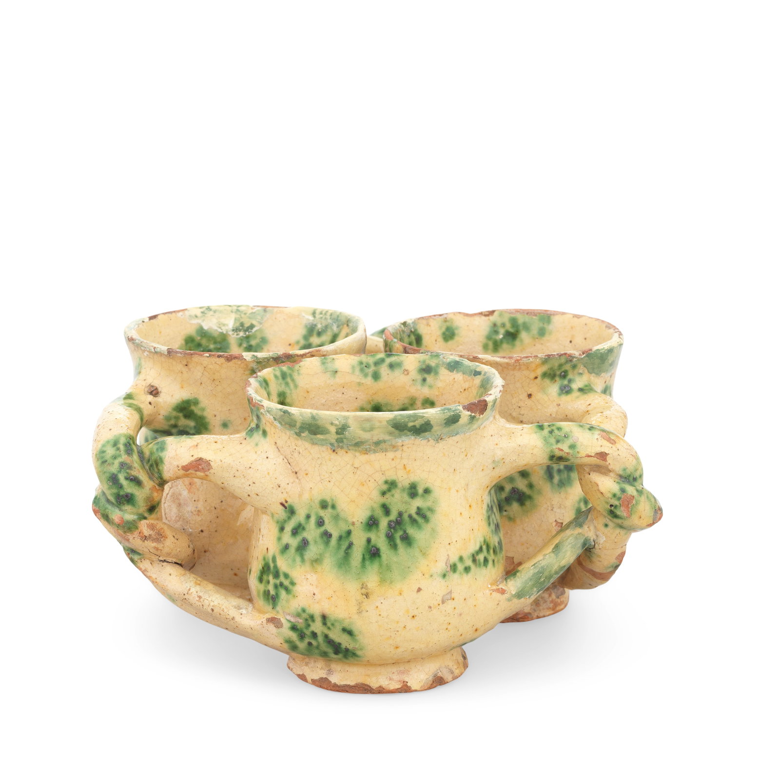 A Donyatt slipware fuddling cup or 'jolly boy', circa 1730-40: A Donyatt slipware fuddling cup or 'jolly boy', circa 1730-40 Formed as three conjoined vessels with globular bodies and neat spreading feet, linked through holes in their walls and by twisted handles