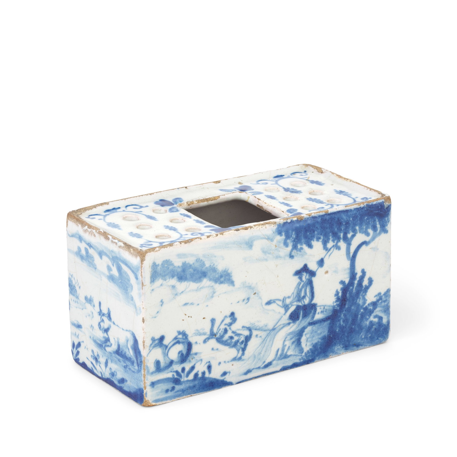 An English delftware flower brick, circa 1750-60: An English delftware flower brick, circa 1750-60 Of large rectangular form, painted in blue with bucolic scenes, a shepherd and his dog minding well-fed sheep, on the other side a shepherdess similarl