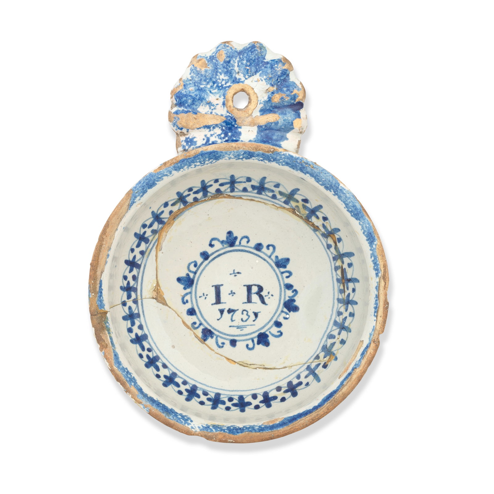 An English delftware porringer, dated 1731: An English delftware porringer, dated 1731 Probably Bristol, the circular bowl with a pierced shell-form handle, painted in blue with formal borders, the interior inscribed and dated with the initials