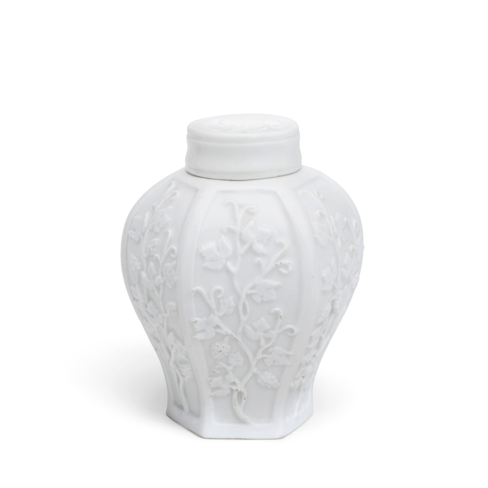 A Meissen hexagonal tea canister and cover, circa 1725-30: A Meissen hexagonal tea canister and cover, circa 1725-30 Each panel with relief decoration of fruiting vines, the cover with a similar sprig on the top, 10.2cm high, faint traces of blue crossed swor