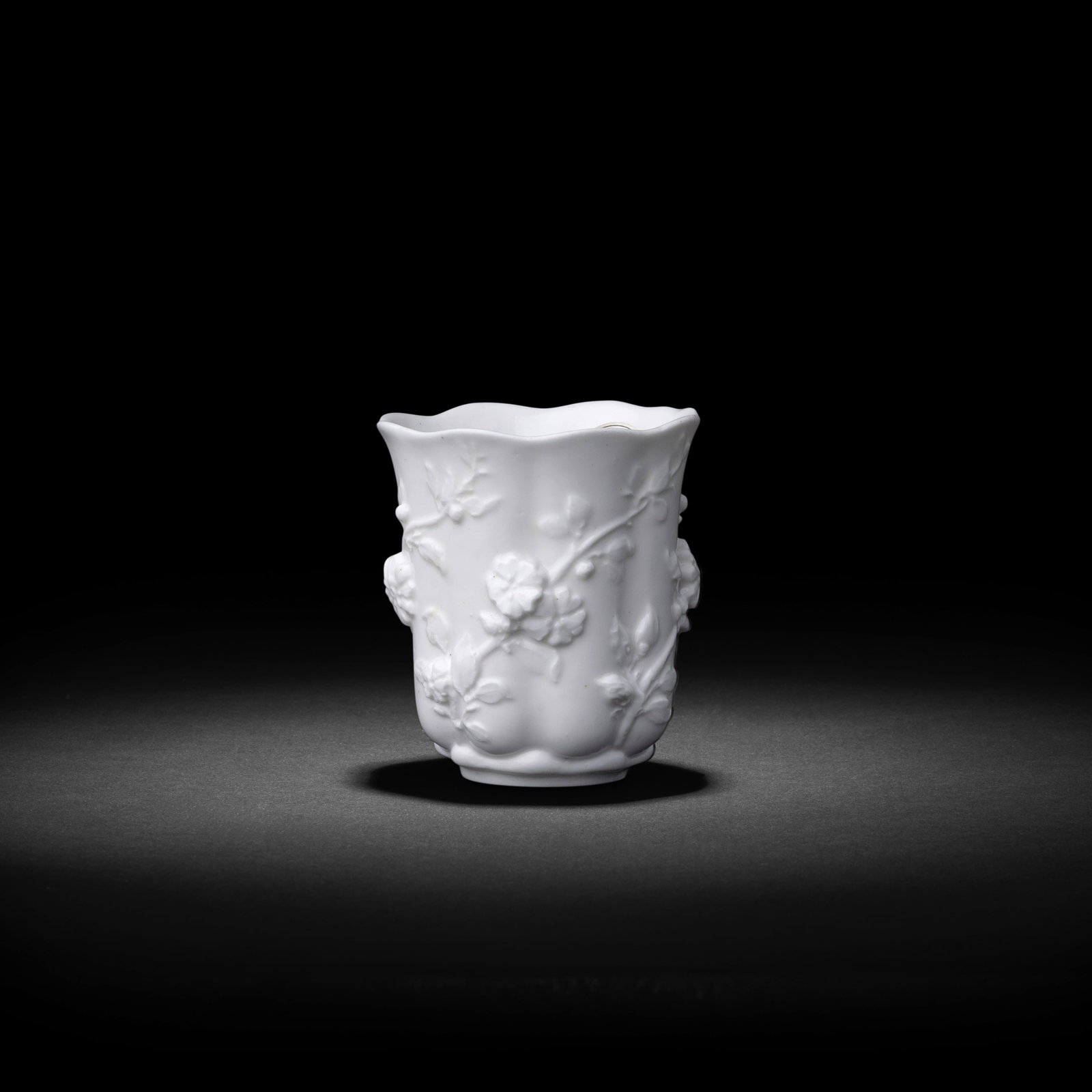 An extremely rare Chelsea white 'teaplant' beaker, circa 1745-49: An extremely rare Chelsea white 'teaplant' beaker, circa 1745-49 The gently lobed form with the rim slightly everted, moulded in high relief with five spiralling leafy tendrils issuing buds and flower